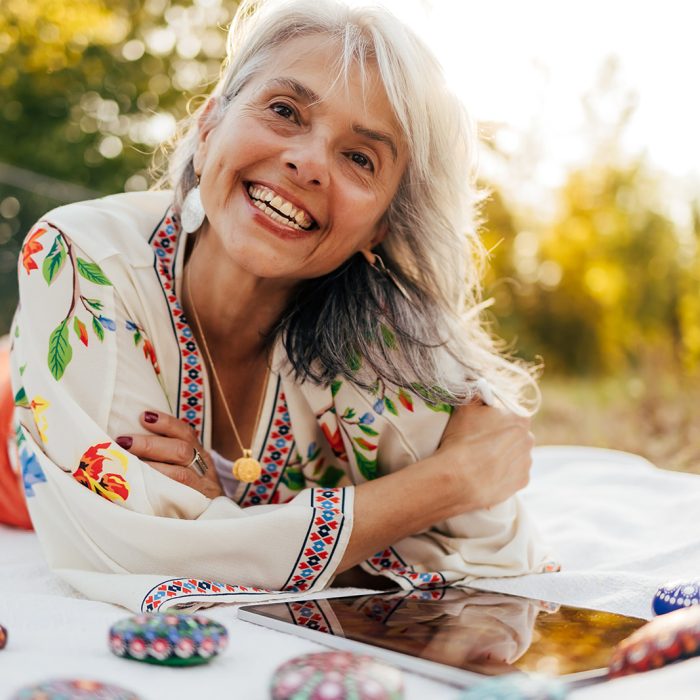 Sacreah, artist, working in her outdoors studio.